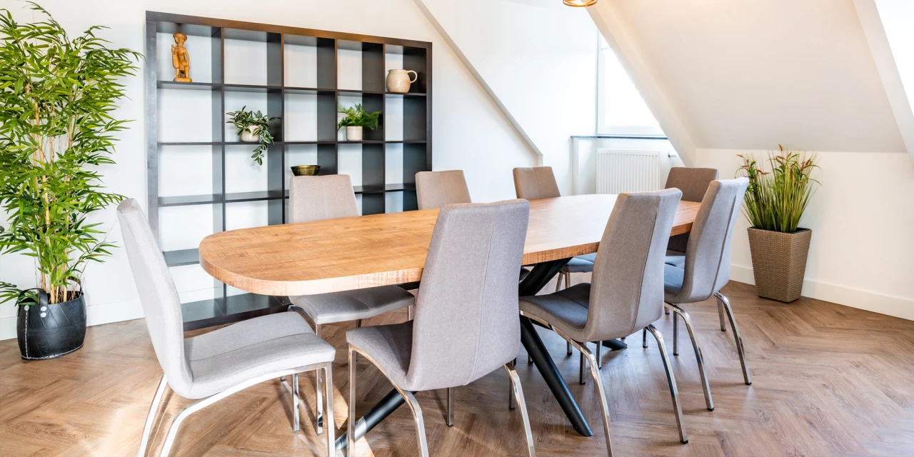 Vergaderruimte met ovale houten tafel en stoelen in afkickkliniek Eindhoven