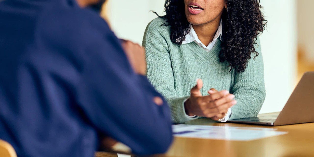 Behandelaar is in gesprek tijdens een intakegesprek over de behandelingen en het persoonlijk advies. 